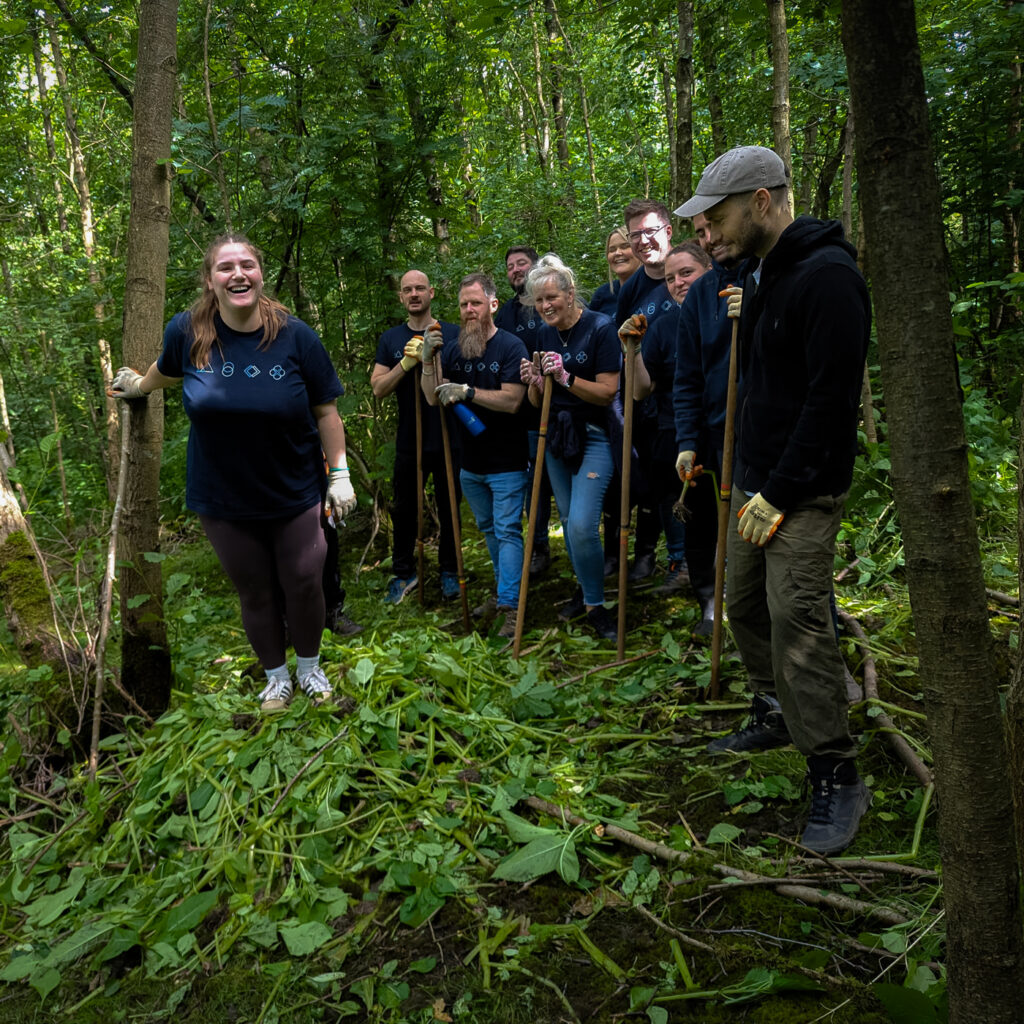 Group shot of the Far'n'Beyond team stood next to Balsam that they have taken out of the ground